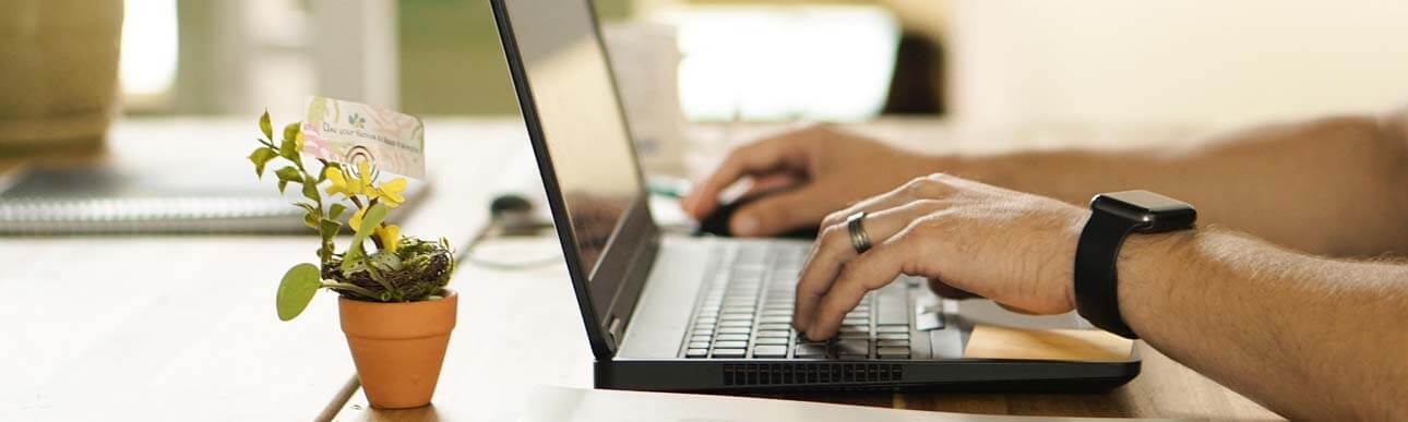 Male's hands working at a laptop